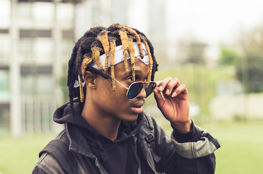 A young man with dry and flat dreadlocks.