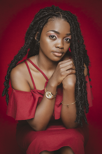 A model in a red dress with long two-strand dreadlocks.