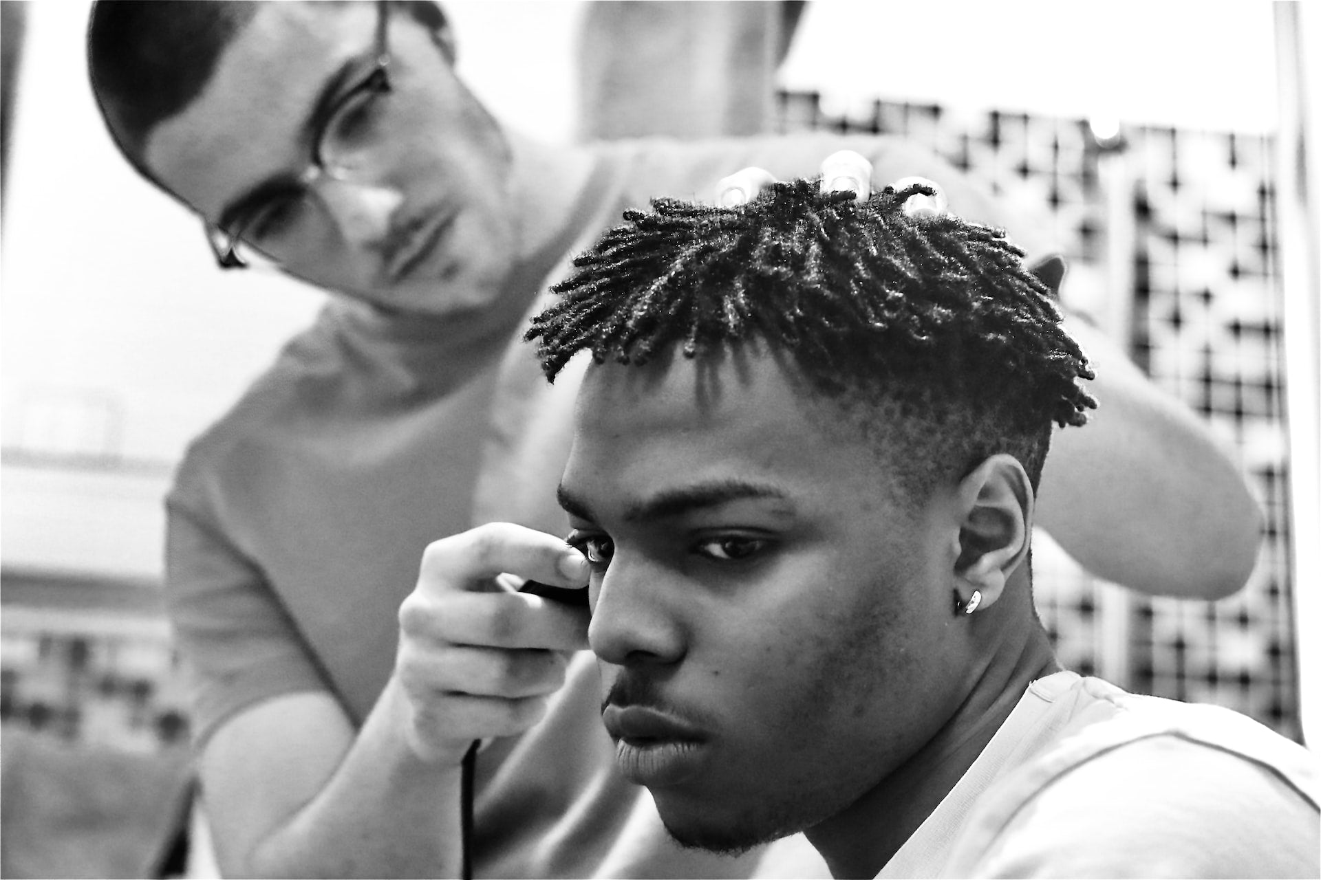 A man with baby locs getting a line up