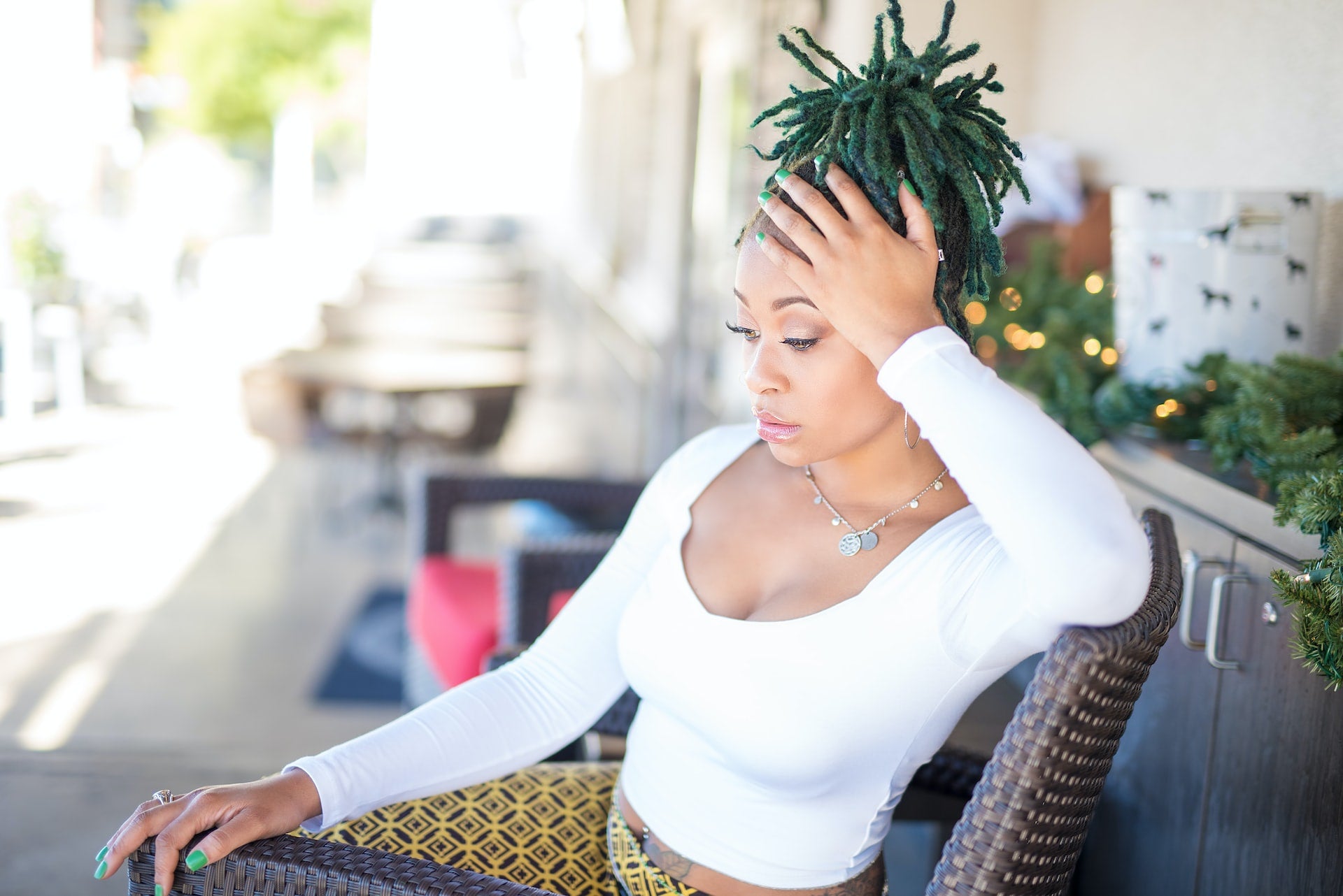 A woman touching her dreads