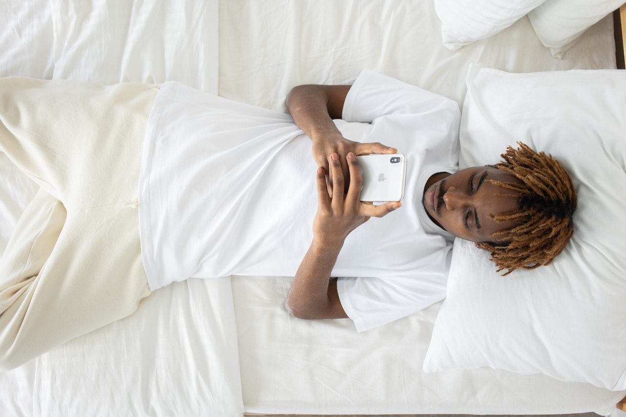 a man with dreadlocks using a cell phone
