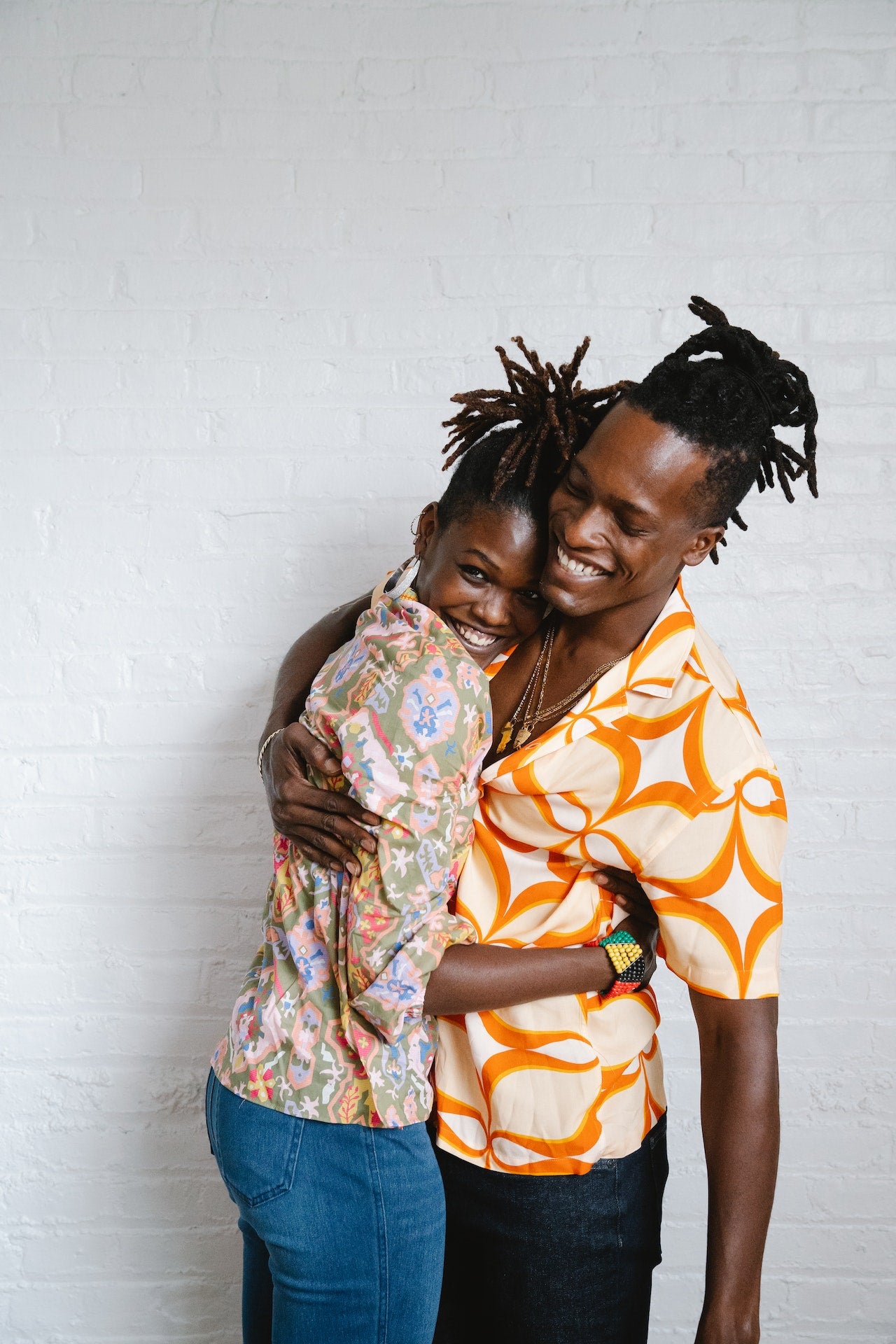 a couple with dreadlocks hugging