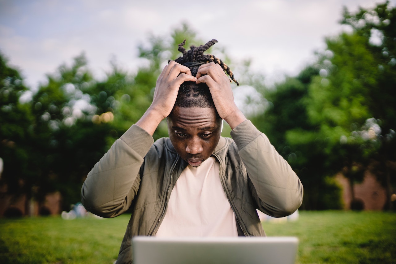 a man with dreadlocks pulling on hair