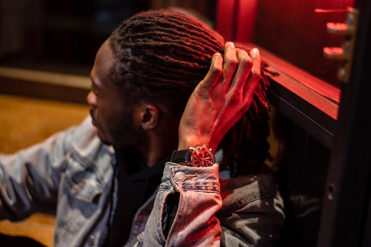 a man touching his dreadlocks