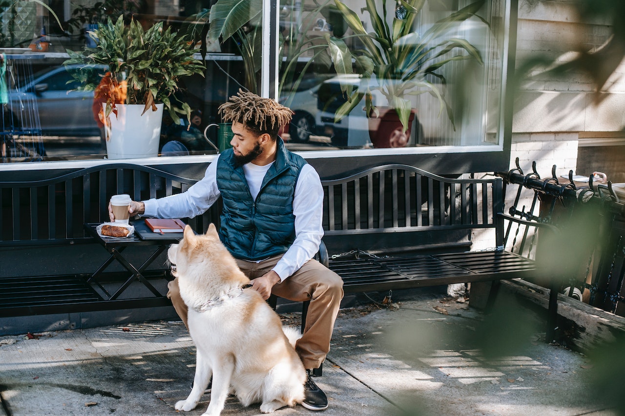 a man with dreadlocks drinking coffee