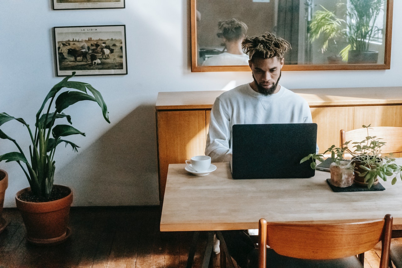 man with dreadlocks using a computer
