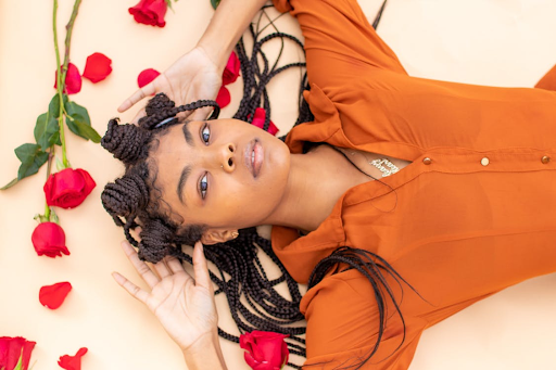 A model with Bantu knots posing with roses. 