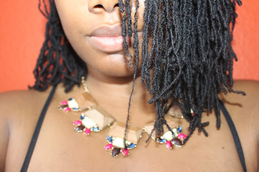 Close up view of woman with thin dreadlocks.