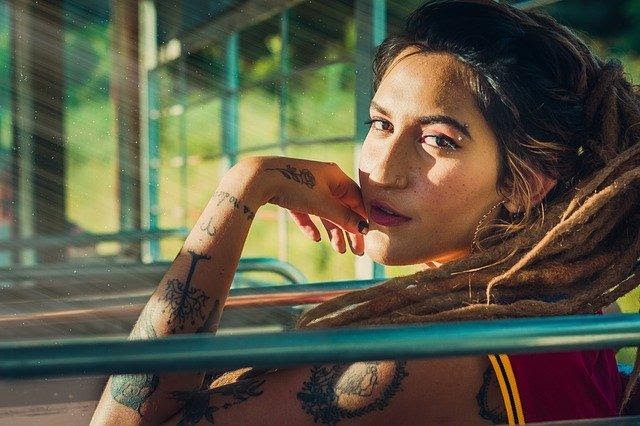 Woman with dreadlocks and tattoos