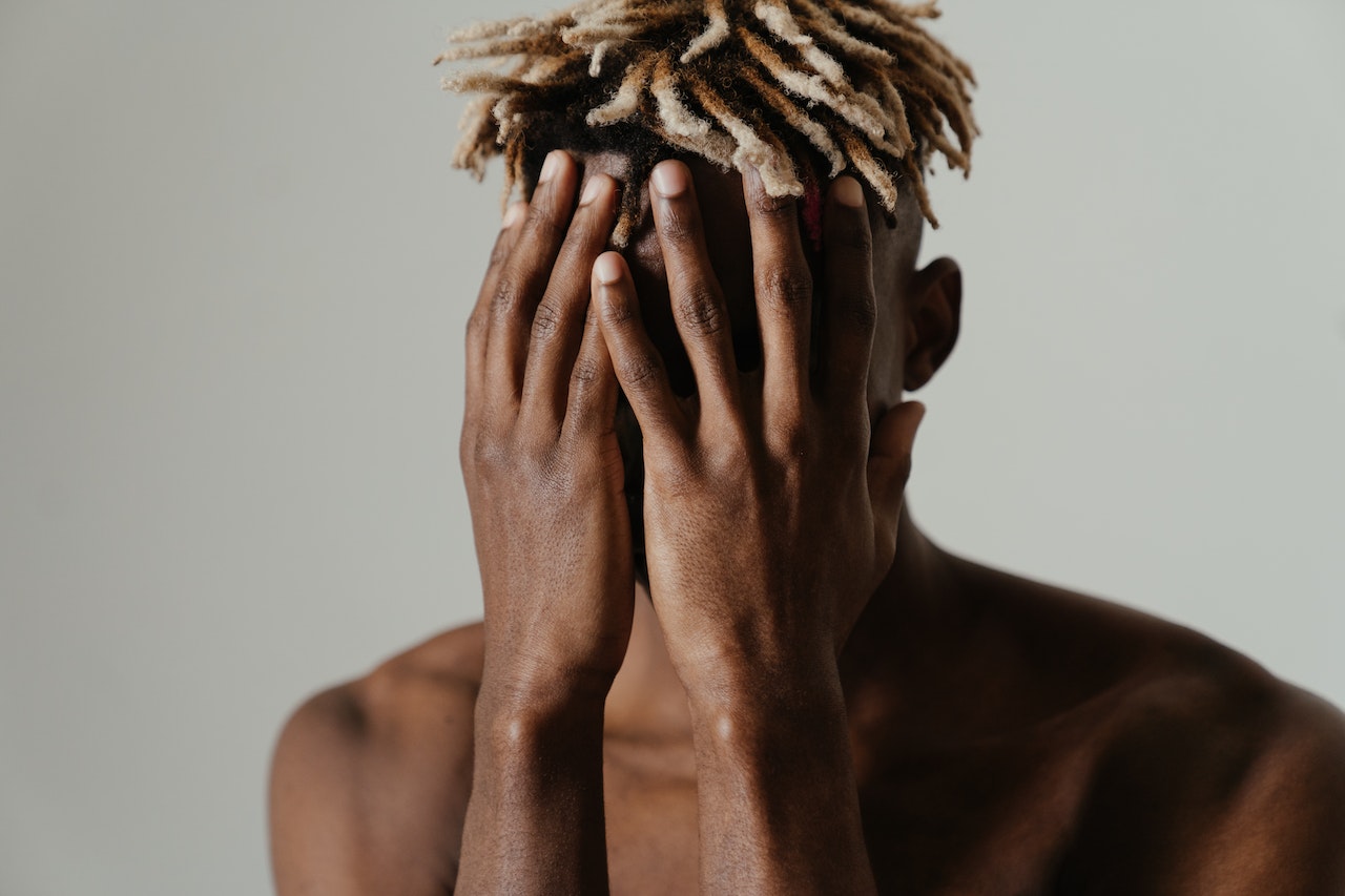 a man with nice dreadlocks covering his face