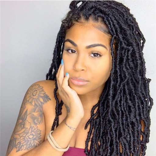 Woman with long soft locs.